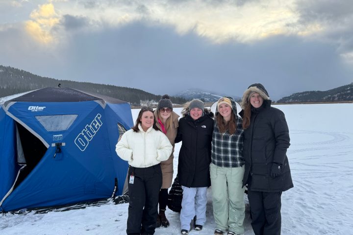 a group of people posing for a picture in the snow