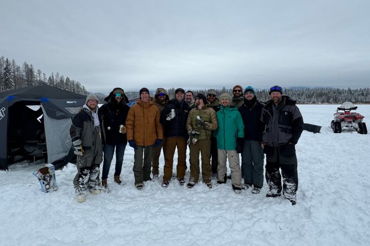 a group of people standing in the snow