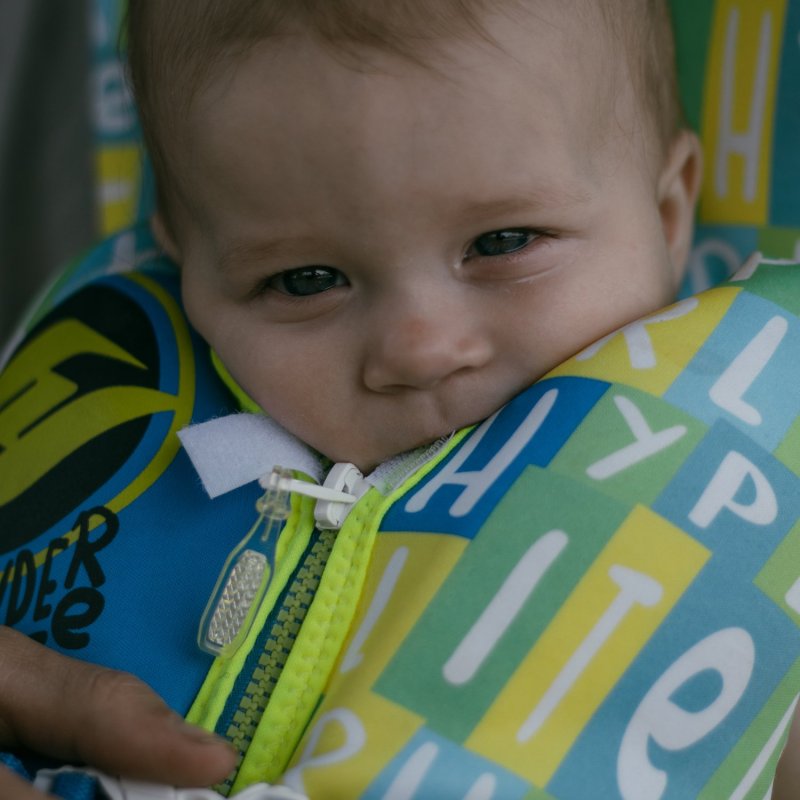 a little boy holding a baby