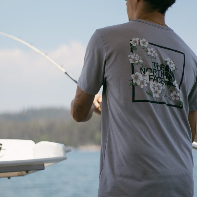 a man standing in front of water