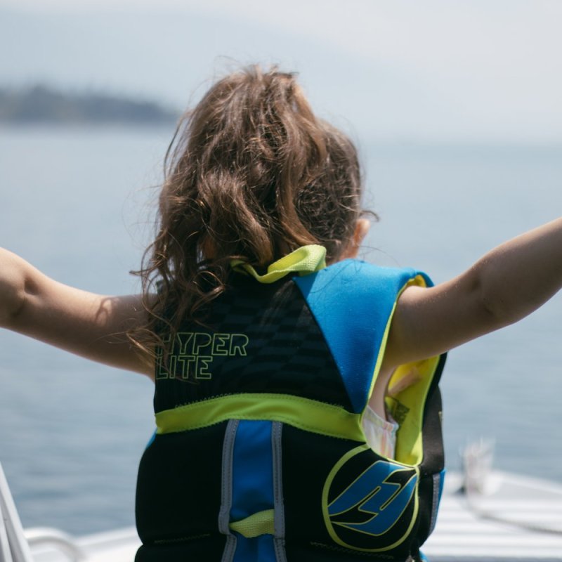a woman standing next to a body of water