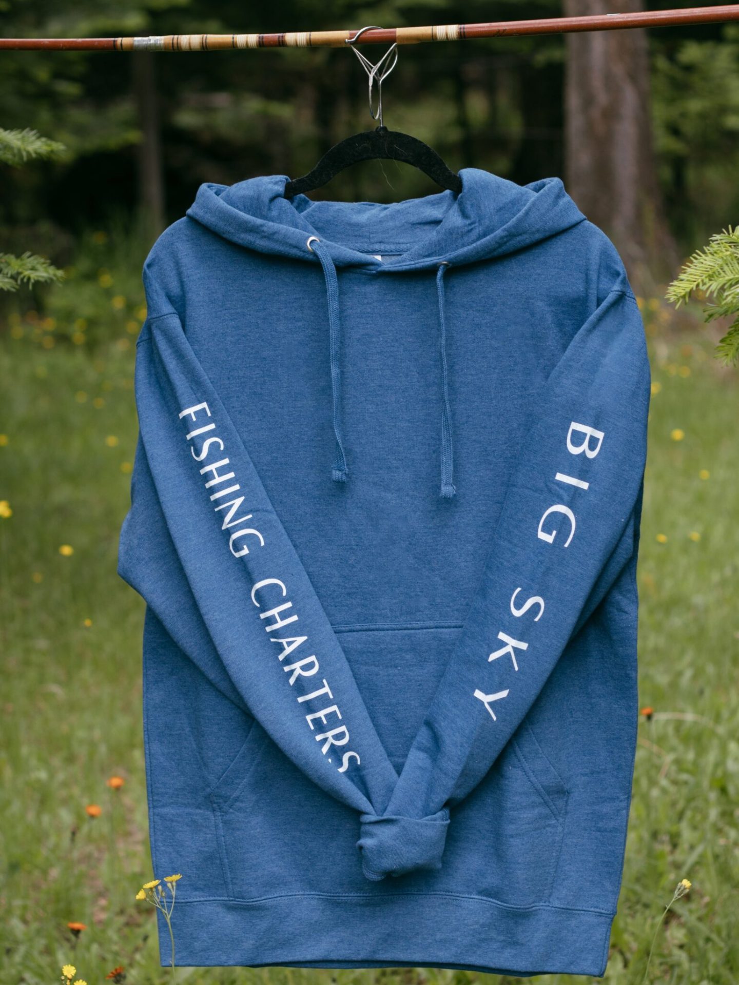 a person wearing a blue jacket standing in the grass