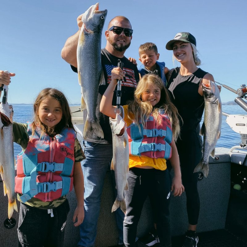 Ksenia Pervak et al. standing next to a body of water