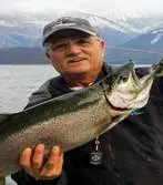 a person holding a fish in the water